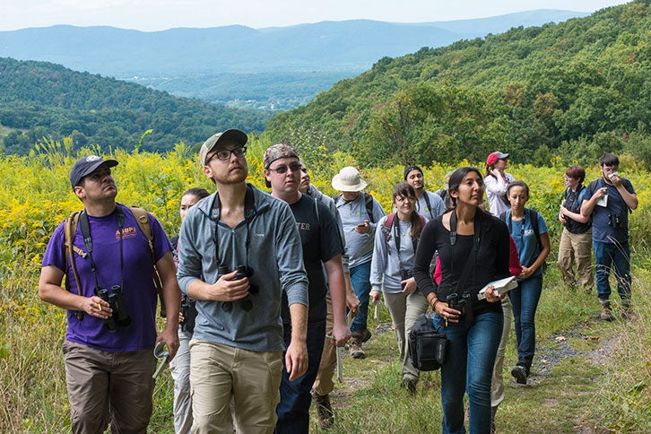 Smithsonian Mason students walk through the mountains on the grounds of the Smithsonian Biology Conservation Institute 