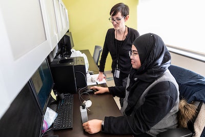 Jenna Krall and grad student at a computer