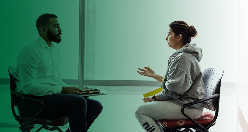 A Mason students talks with an advisor.