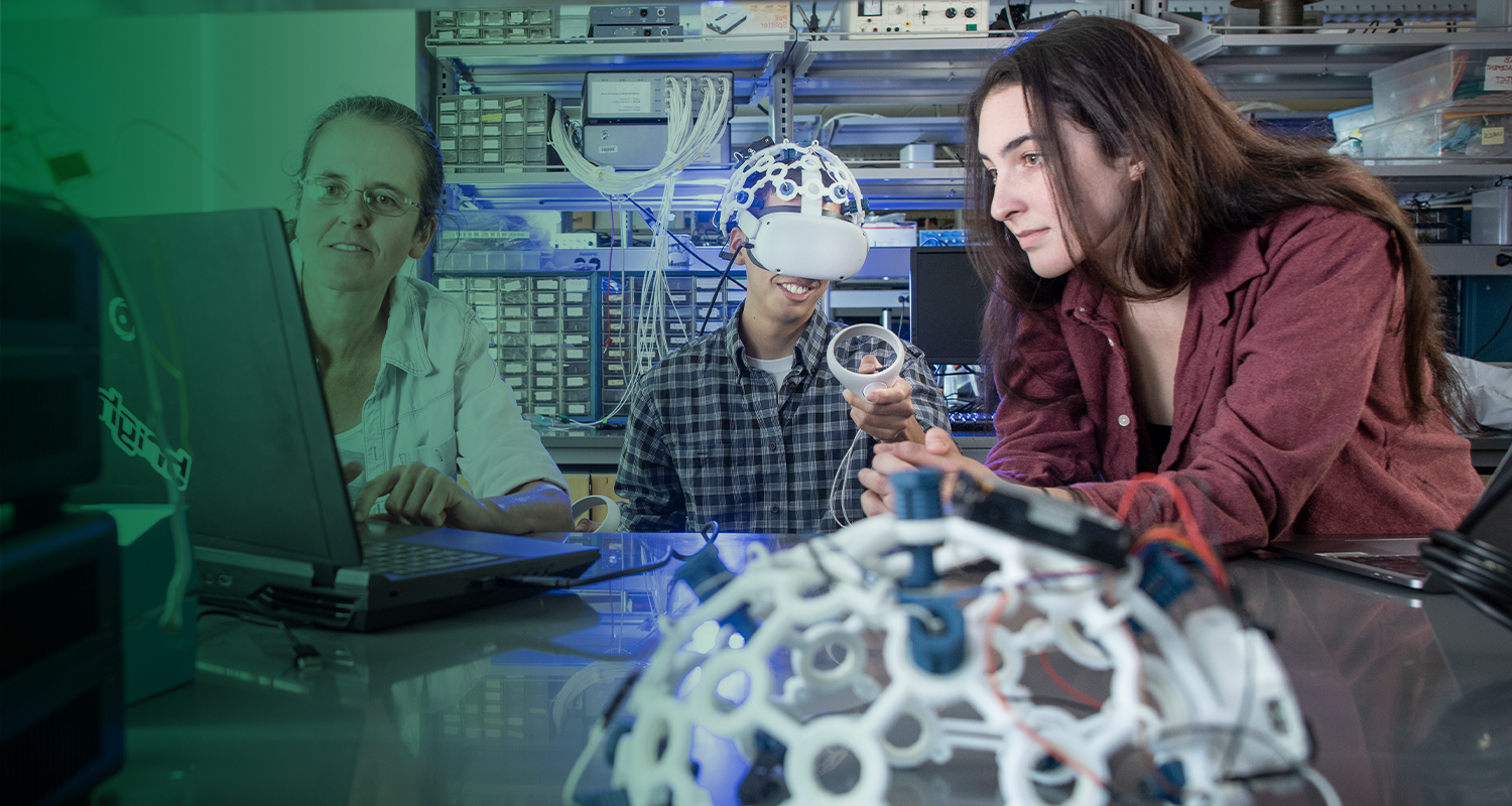 A pair of Mason students collaborate with their professor on a research project.