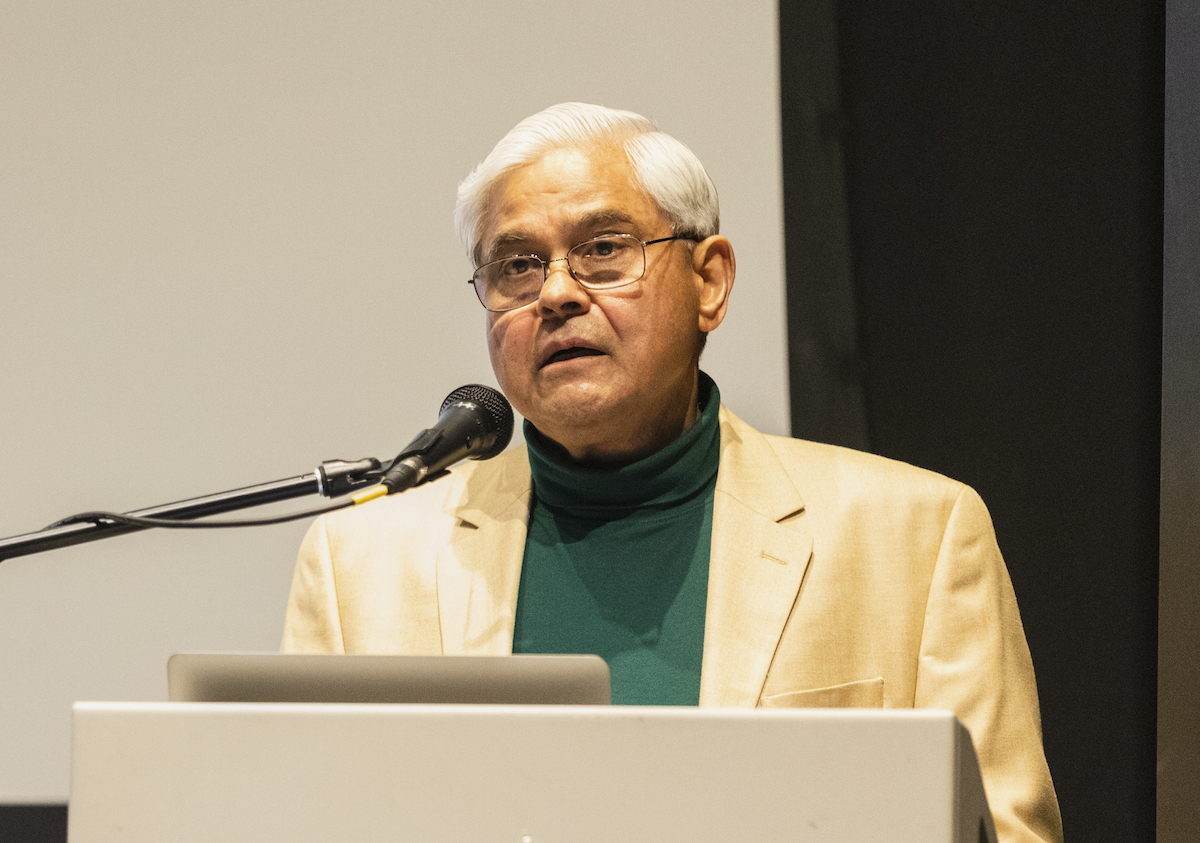 man with glasses at a podium