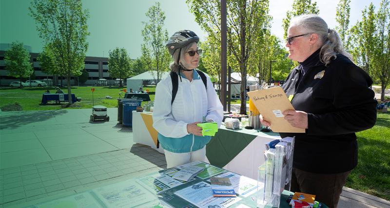A pair of older students stand outside together on the Mason campus